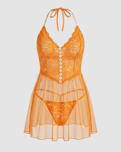 Model wearing the Dreamgirl Orange Floral Lace Babydoll and G-String Set, capturing the flattering silhouette and softness of this elegant floral lace babydoll for a captivating bedroom look.