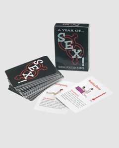 A set of dice for the A Year Of Sex! couples card game by 1on1, featuring colorful dice with various sexual position illustrations.