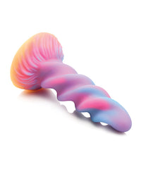 a pink, blue, and purple swirling unicorn horn dildo with an orange suction base lying on its side by creature cocks