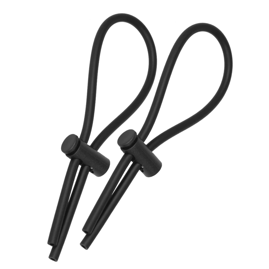 a pair of black ear buds on a black background