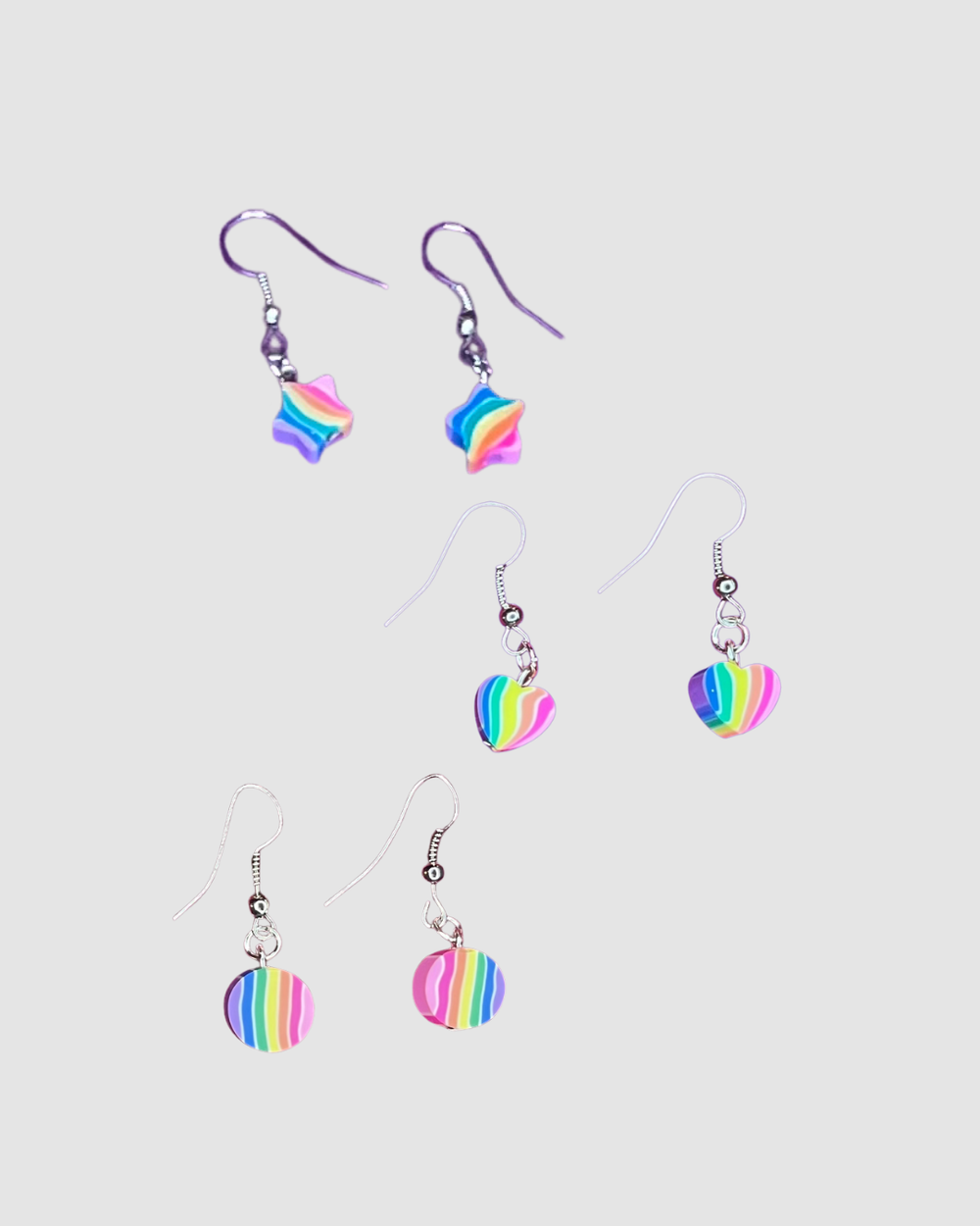Colorful rainbow drop earrings by Swing Bling, featuring vibrant, dangling jewelry with rainbow-colored beads and shiny accents.