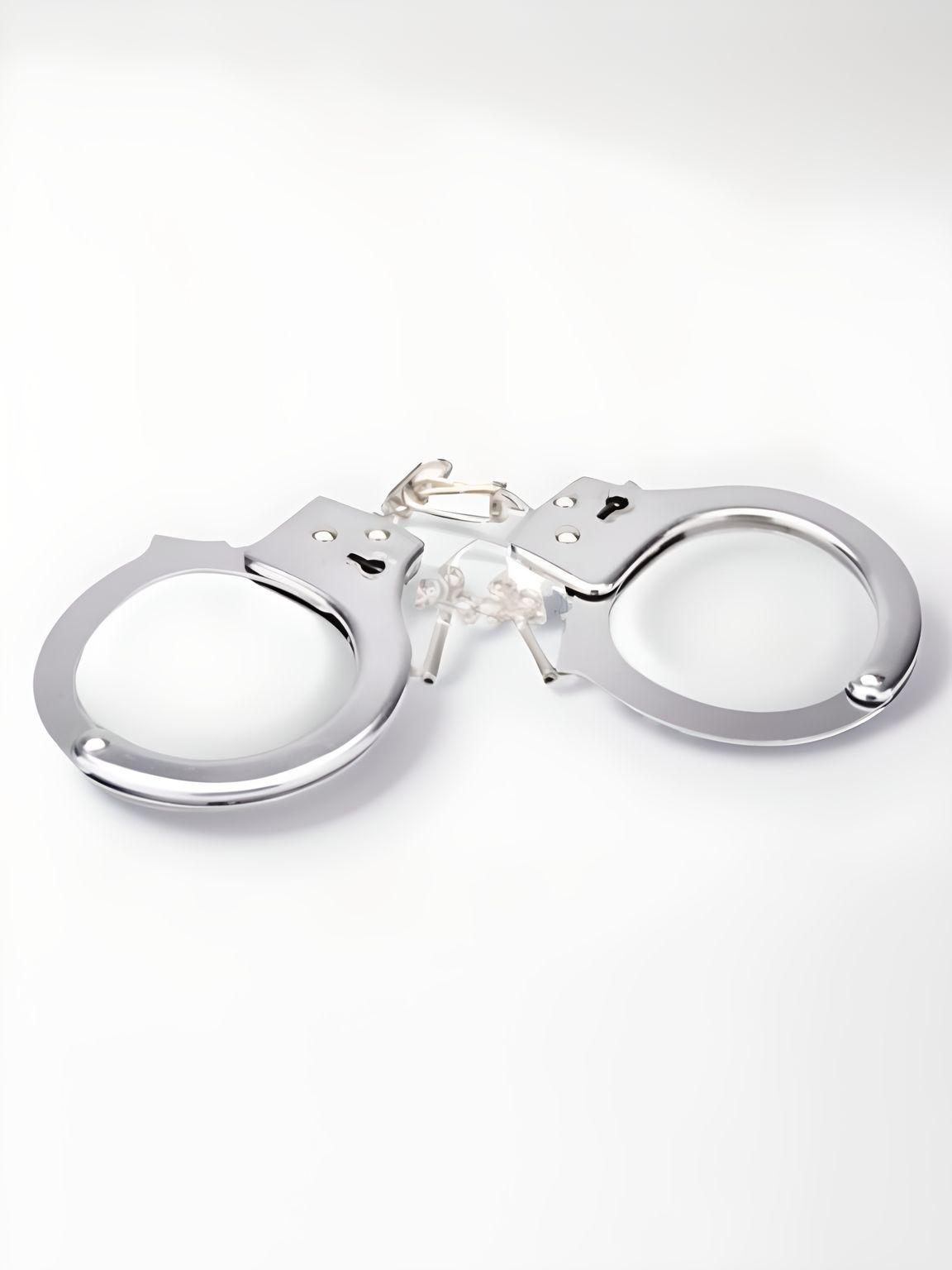 Bound to Play heavy-duty metal handcuffs with quick-release unlocking system, shown with secure locking mechanism and durable construction.