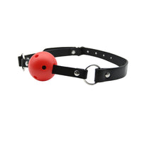 A striking red ball gag with breathable features, set against a sophisticated black strap for premium comfort.