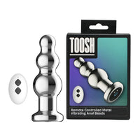 Toosh Remote Controlled Metal Vibrating Anal Beads elegantly arranged with magnetic USB charger, representing sophistication in intimate playtime.