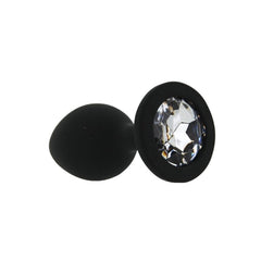 Black plug with a clear gemstone on a white background