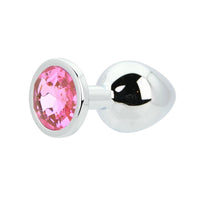 Luxury Toosh Metal Butt Plug with Pink Stone, artistically displayed against a soft background, emphasising its sophistication.