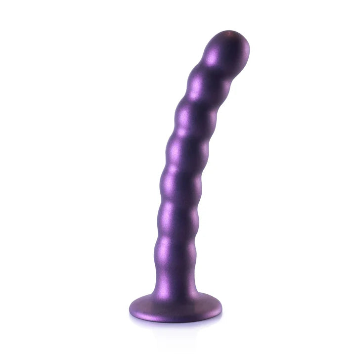 a shiny purple dilll sitting on top of a white table