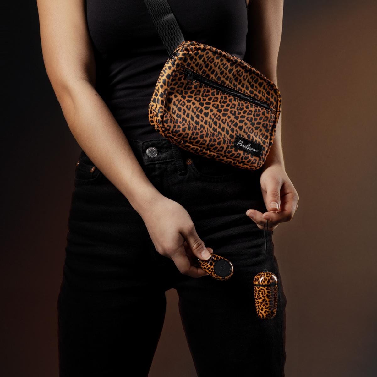 a woman is holding a leopard print purse