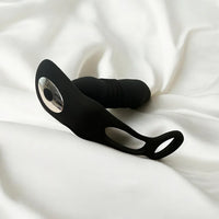 a prostate massager laying on top of a white sheet