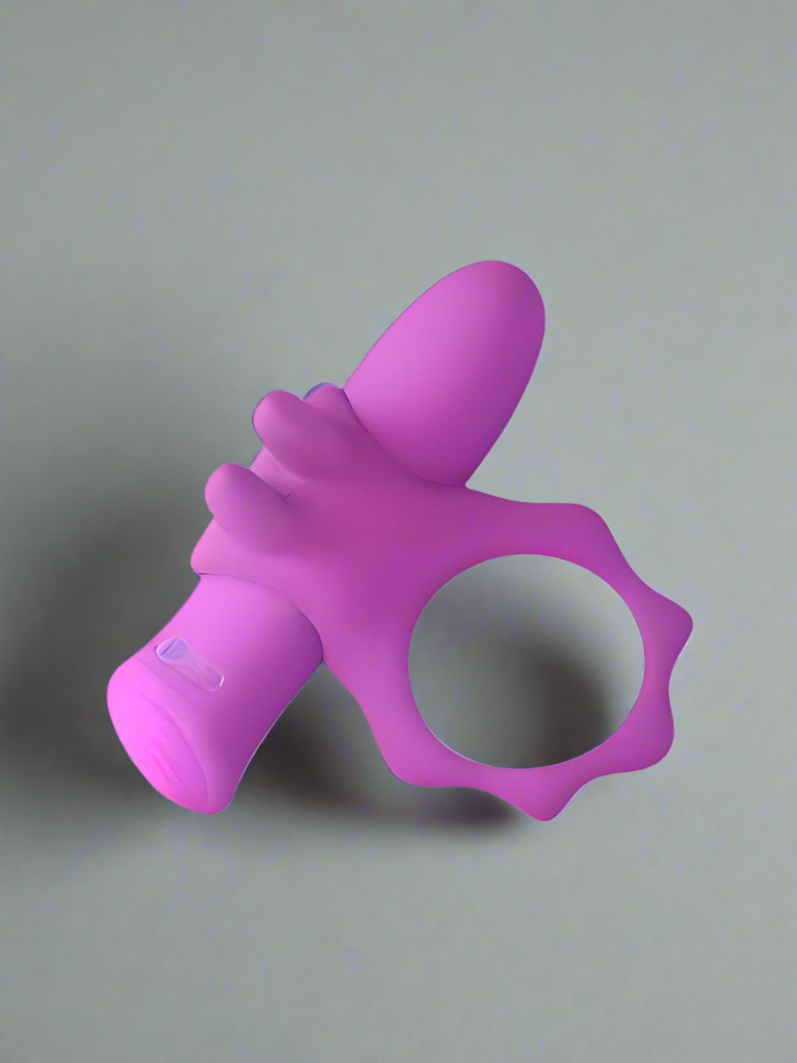 a pink plastic object on a gray surface