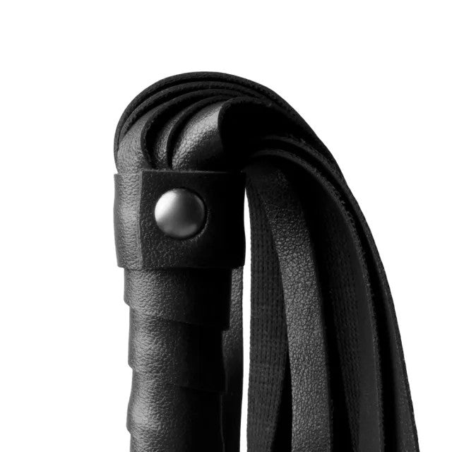 Close-up of a black leather strap with a metal buckle on a white background