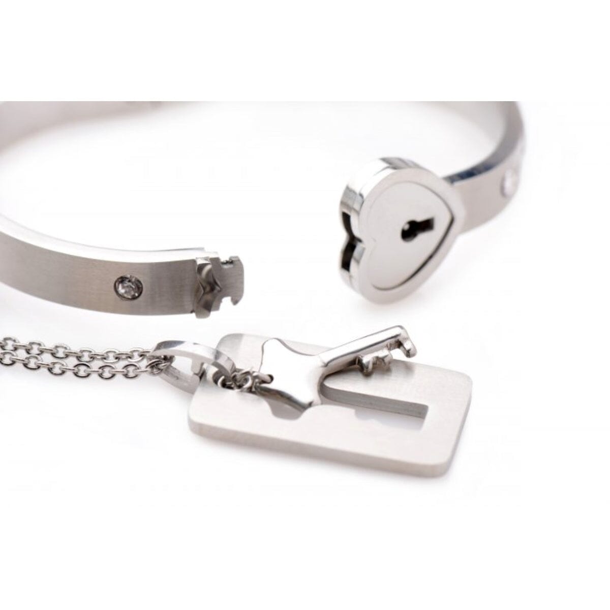 Cuffed locking bracelet and key necklace in tungsten steel, symbol of commitment, by Master Series jewelry.