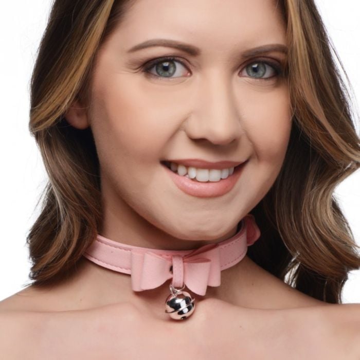 Pink Master Series Sugar Kitty cat collar with silver bell, featuring a cute design on a female model.