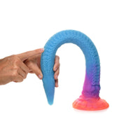 a hand holding a blue and pink object