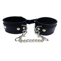 a pair of black leather cuffs with chains