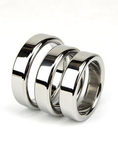 three silver cock rings sitting next to each other on a white abckground