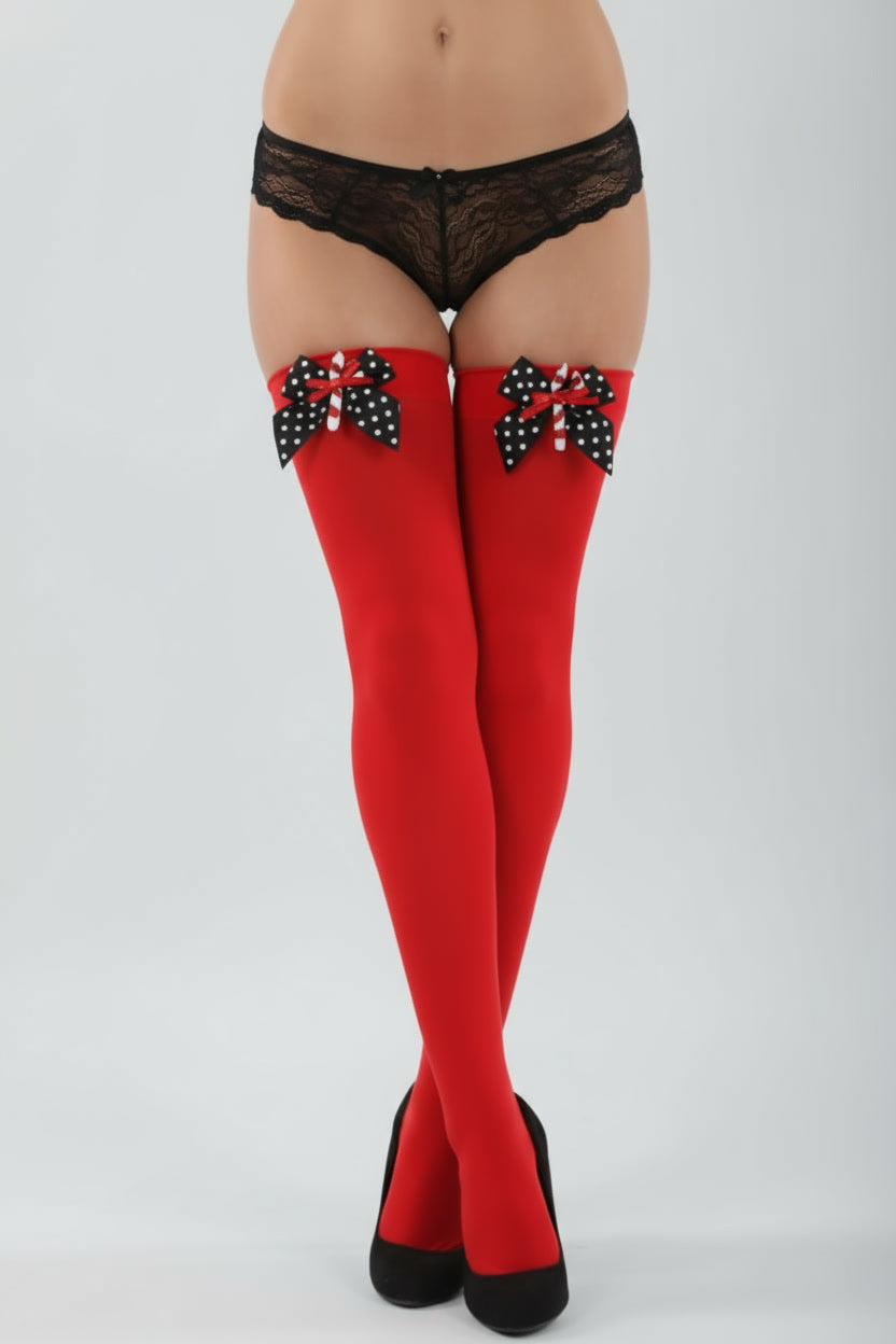 Red opaque Christmas candy cane stockings by Classified, shown on a woman wearing festive holiday hosiery and stockings.