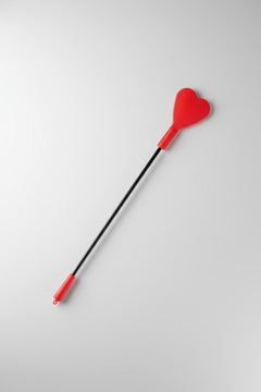 Fetish Fantasy silicone heart-shaped crop in red and black, designed for fetish exploration, with a sleek handle and vibrant color.