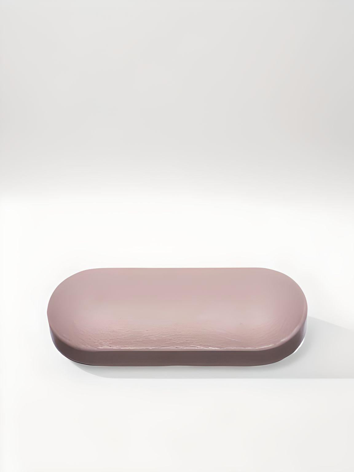 a pink object sitting on top of a white surface