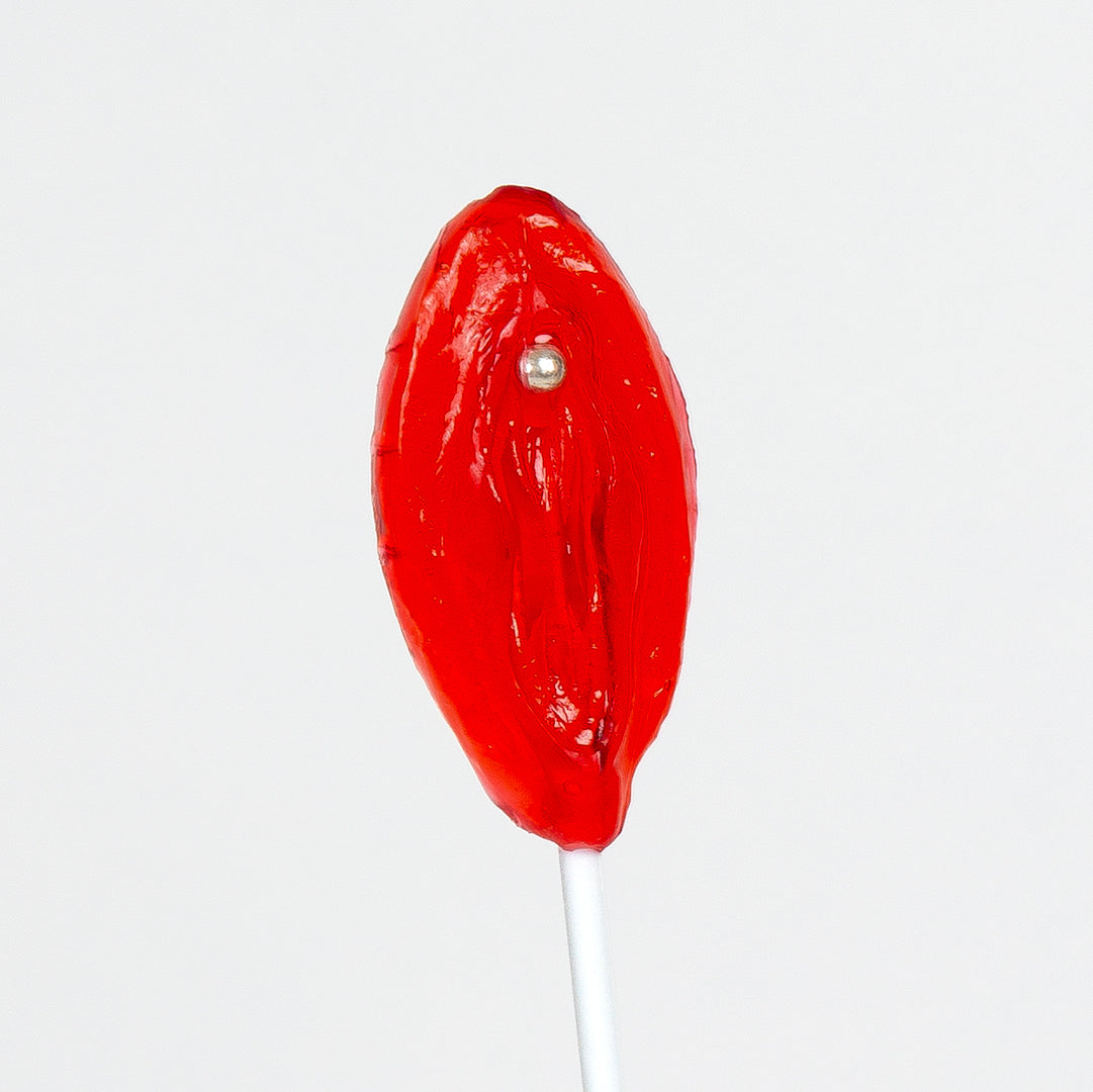 a close up of a red lollipop on a stick