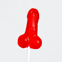 a close up of a red lollipop on a stick