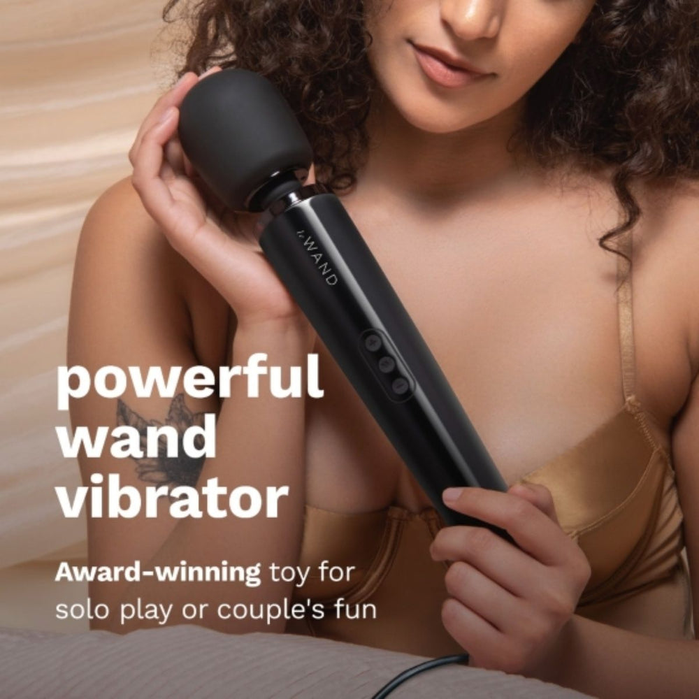 Black Le Wand plug-in vibrating massager with ergonomic handle and flexible head for targeted pleasure and relaxation.