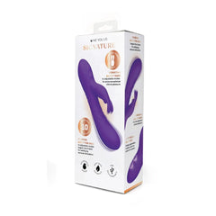 Purple silicone personal massager in its original white and orange packaging, branded 'We You Us Signature'.