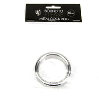 a metal cock ring in a package on a white background