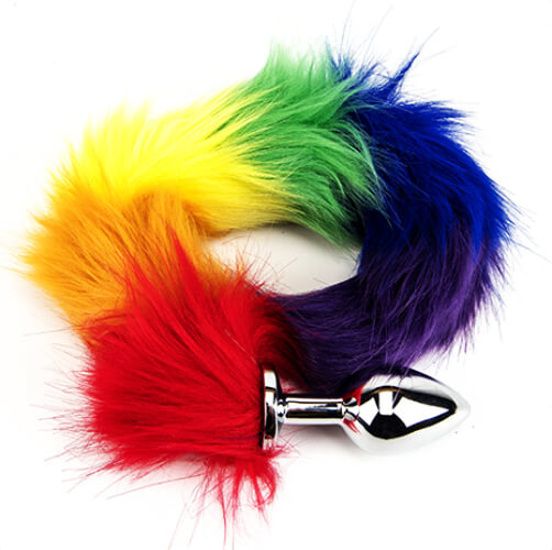 Sensual Furry Fantasy Rainbow Tail Butt Plug in a warm setting, emphasising its potential for temperature play and exquisite craftsmanship.