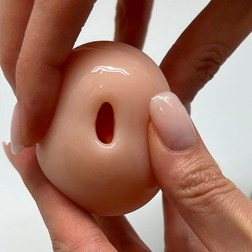 a close up of a person holding a fake doughnut