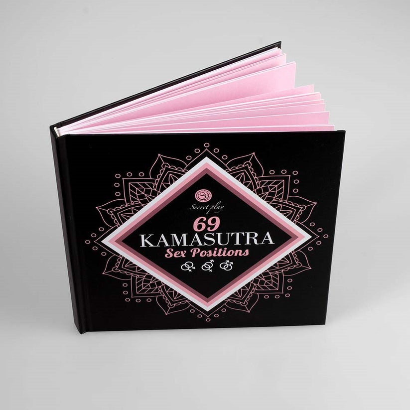 a black book with a pink cover on top of it