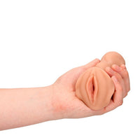 a person's hand holding a fake fake dummy