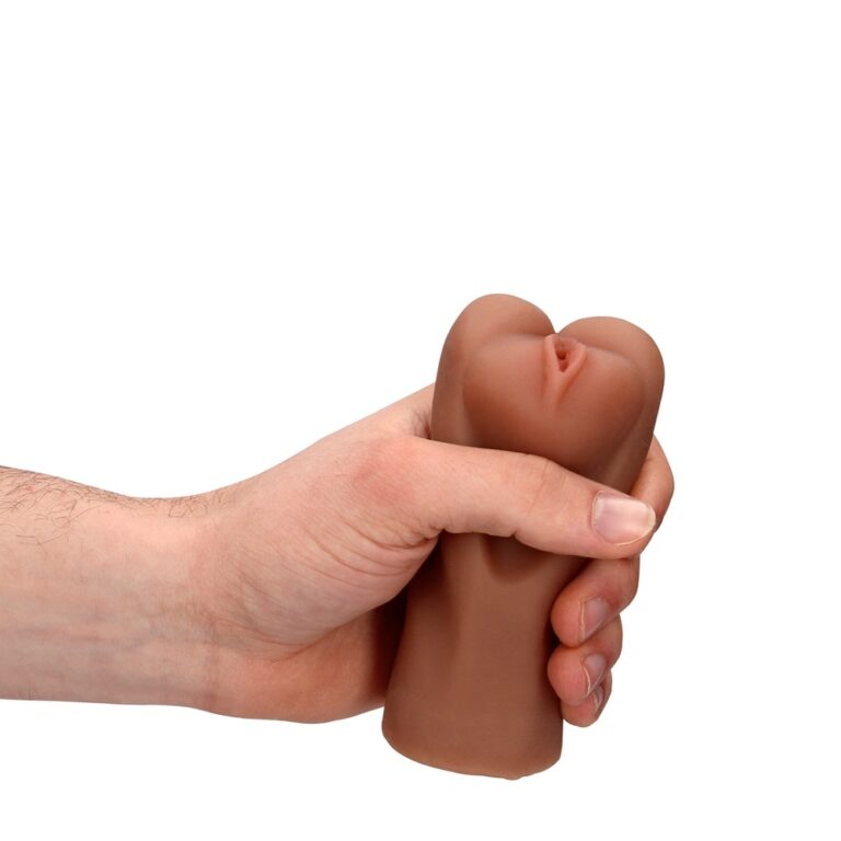 a person's hand holding a fake toy in the shape of a fist