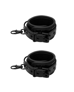 a pair of black leather cuffs on a white background