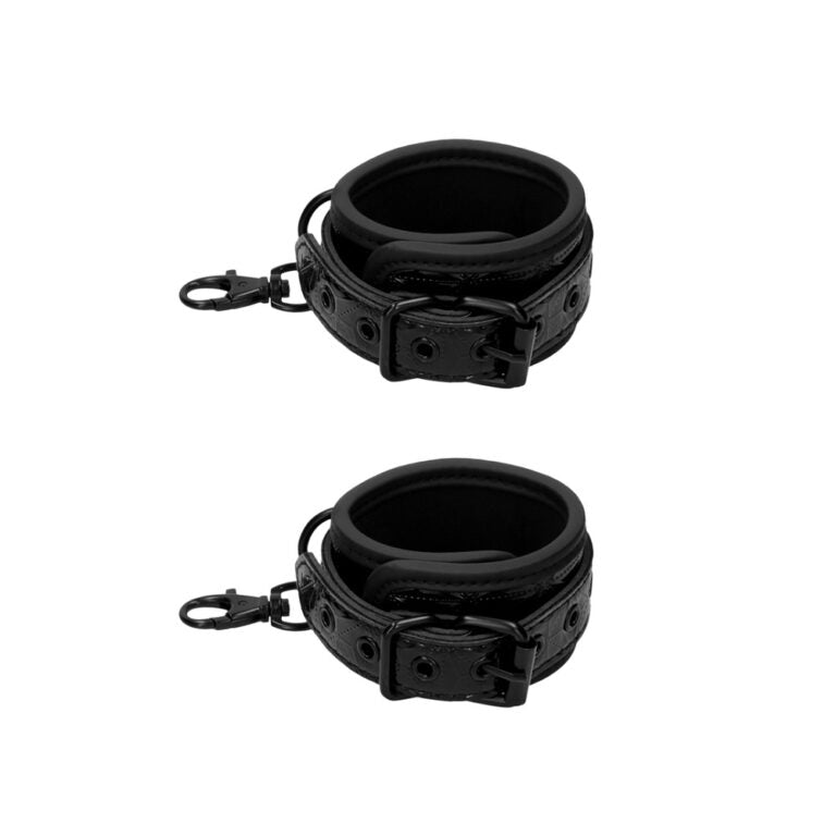 a pair of black leather cuffs on a white background