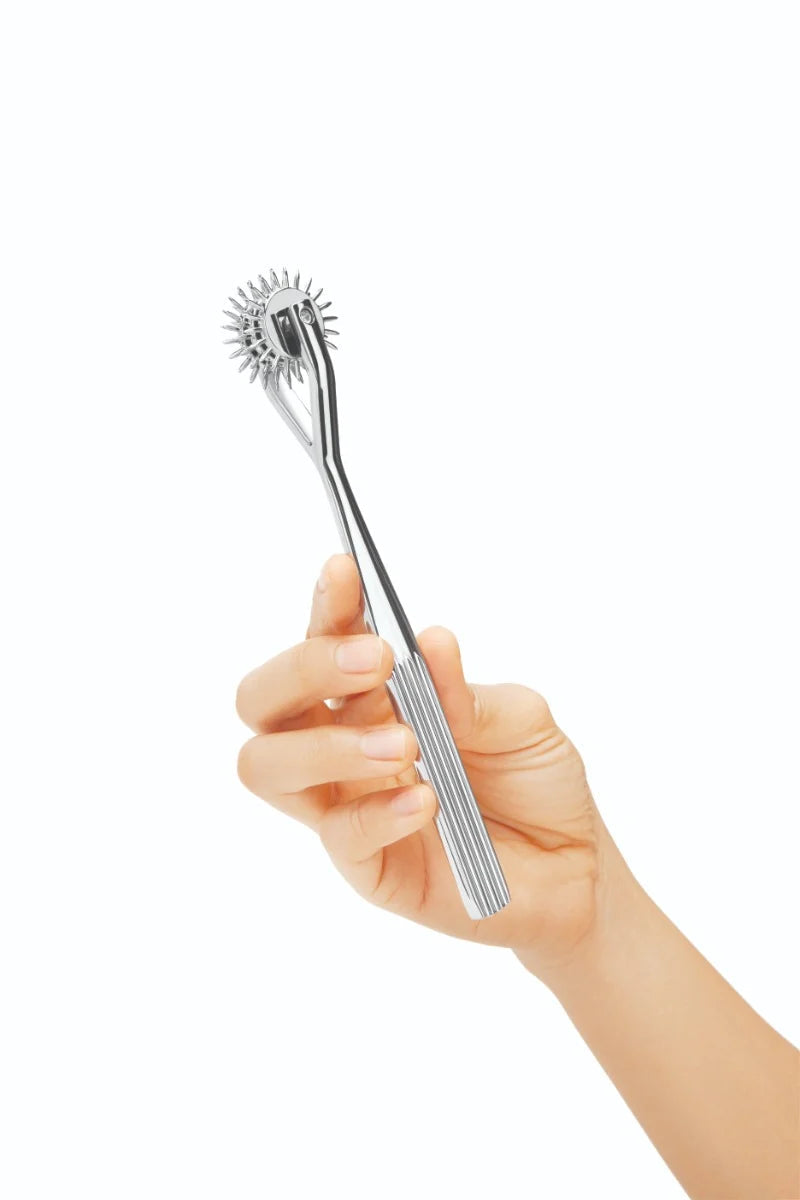 Prowler RED Prowler 3 Pinwheel stainless steel Wartenberg wheel for stimulating skin, shown in close-up.