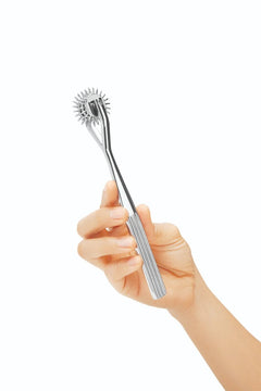 Prowler RED Prowler 3 Pinwheel stainless steel Wartenberg wheel for stimulating skin, shown in close-up.