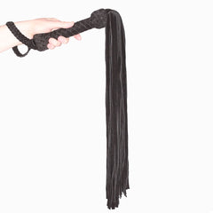 Black or red leather suede flogger by Prowler RED, featuring multiple tails and a sturdy handle for BDSM play.