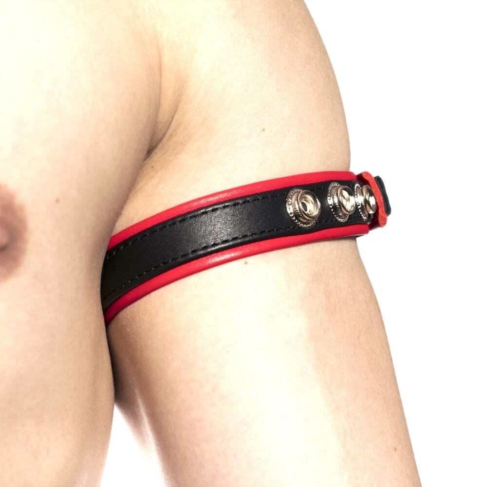 Red Prowler Bicep Band for men, part of Scandals fetishwear collection, shown on a model's arm highlighting its sleek design.