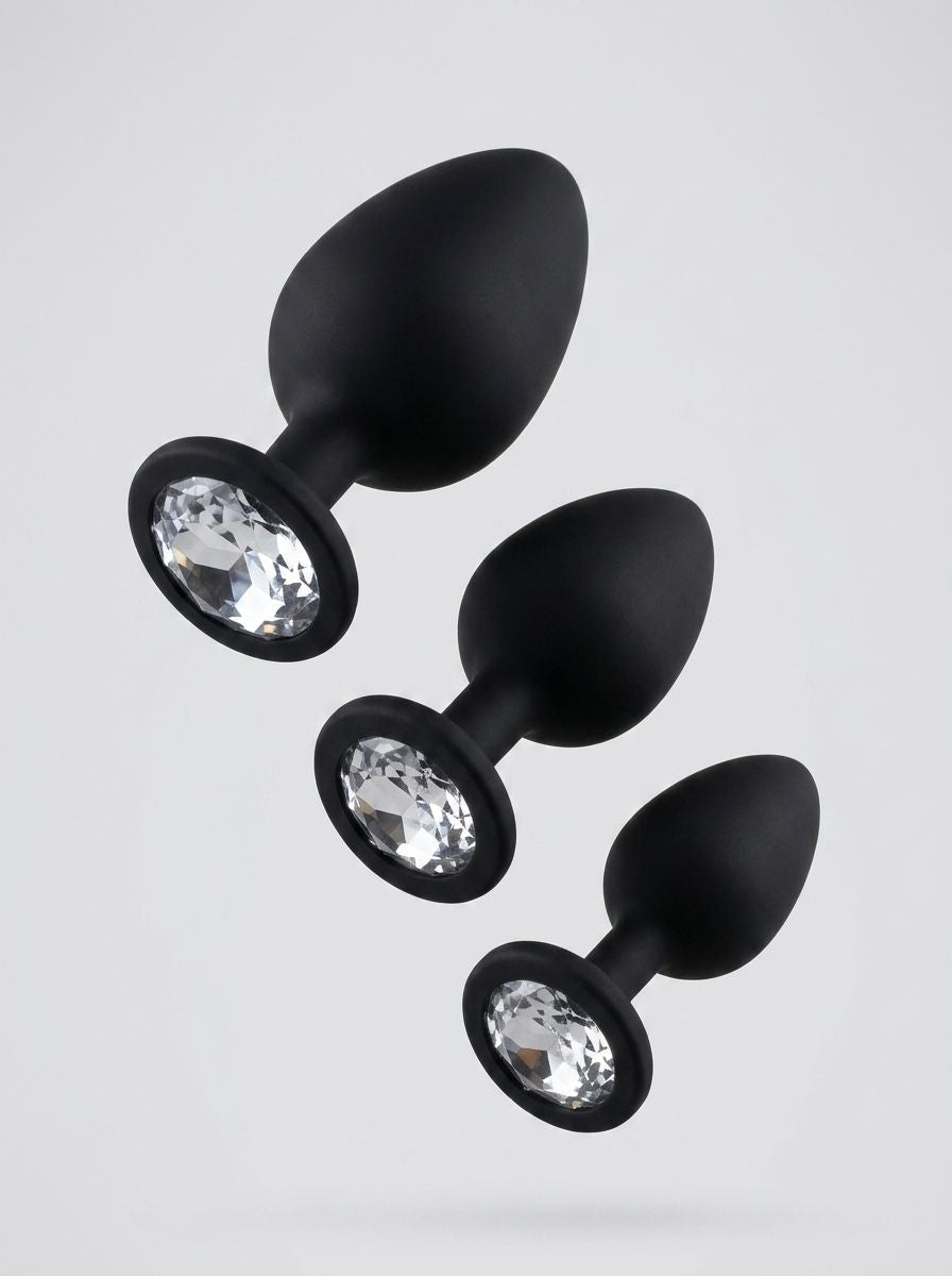 Toosh silicone butt plug set of 3 in black with clear gem bases, smooth and tapered for comfortable use.