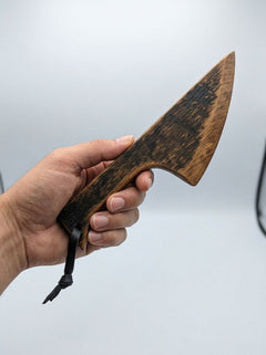 Handcrafted wooden BDSM wax play scraper made from whisky barrel oak, featuring smooth, polished wood with engraved detailing.