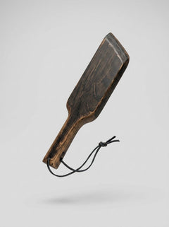 Mini Paddle from Barrel of Pain, a leather flogger for impact play, with a compact design and textured surface.