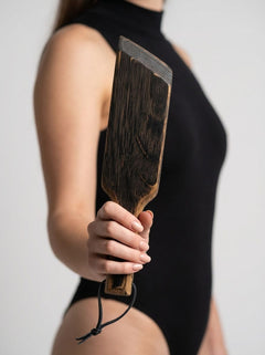 Mini Paddle from Barrel of Pain, a black leather flogger with a compact design, ideal for sensory play and light impact sensations.