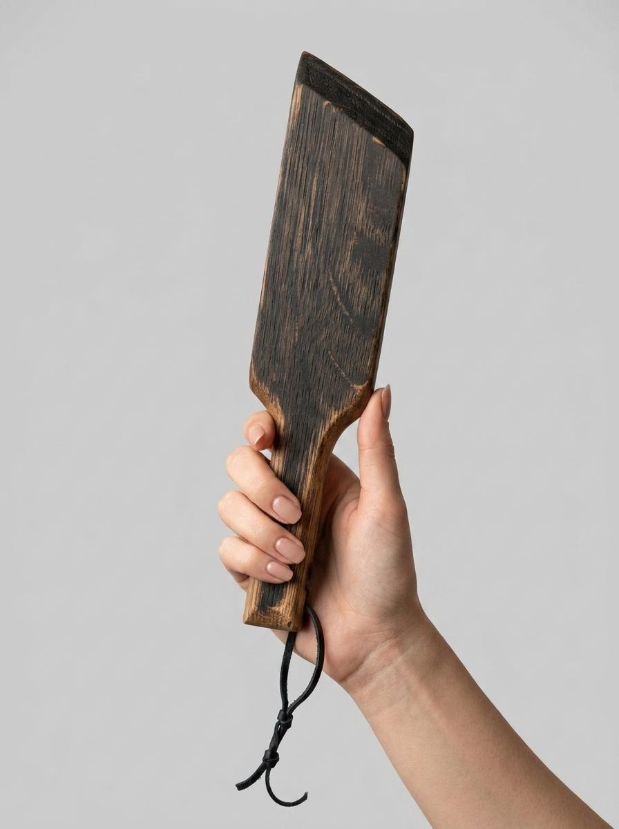 Mini paddle from Barrel of Pain with a smooth wooden surface and ergonomic handle for impact play.