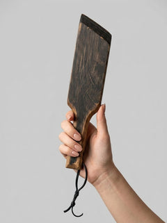 Mini paddle from Barrel of Pain with a smooth wooden surface and ergonomic handle for impact play.