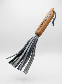 Barrel of Pain handcrafted mini BDSM flogger with whisky barrel oak handle and repurposed leather strands.