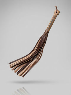Handcrafted Barrel of Pain BDSM flogger with whisky barrel oak handle and repurposed leather lashes, designed for heavy weight kink play.