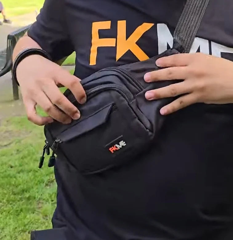 FKME Bumbag in black with adjustable strap and zippered compartments, designed for convenient carrying and style.