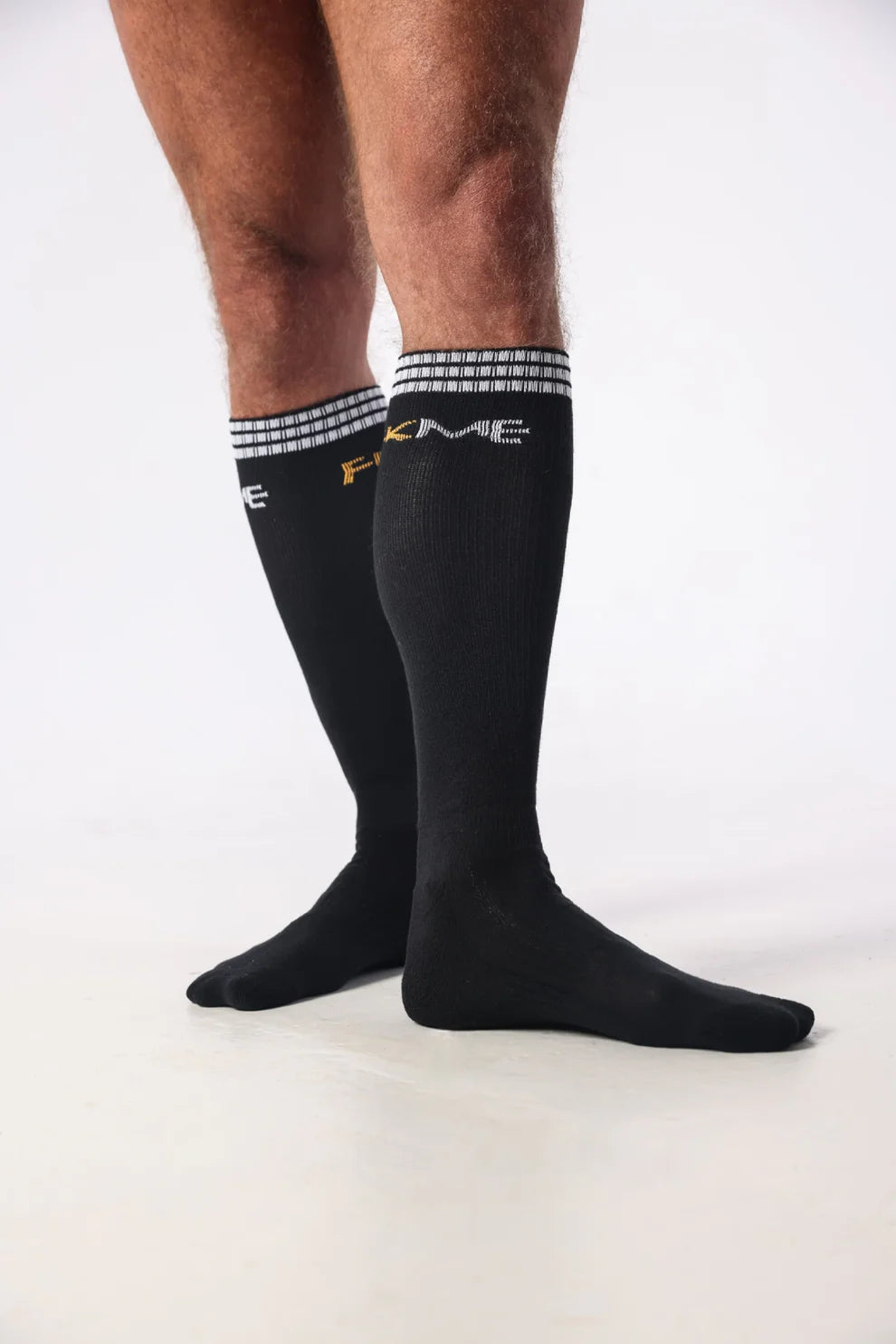 Luxurious FKME Knee High Socks showcased in a trendy urban environment, emphasizing comfort and style for gym or casual wear.