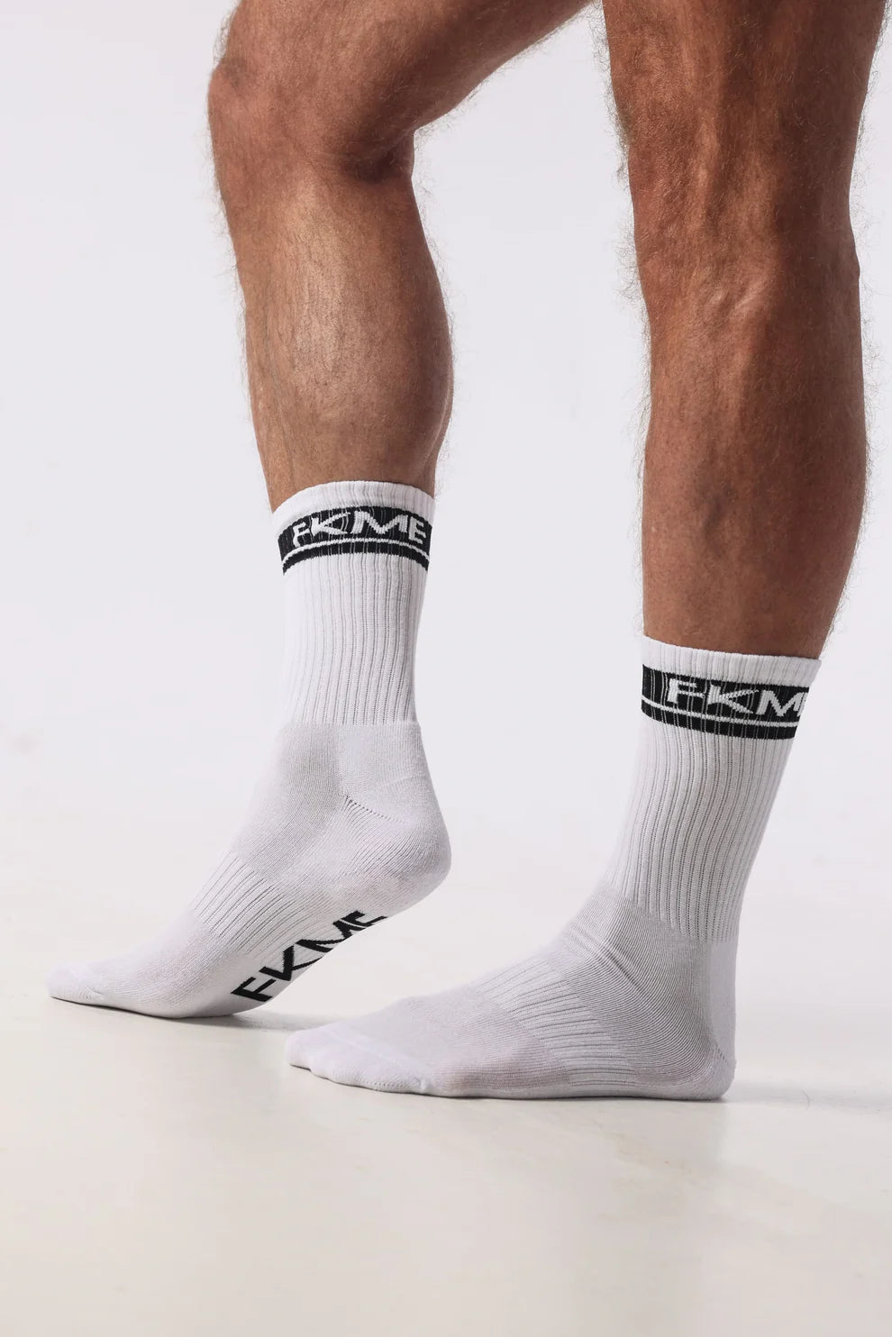FKME Logo Socks showing a close-up of black socks with white FKME logo branding, comfortable and stylish for everyday wear.